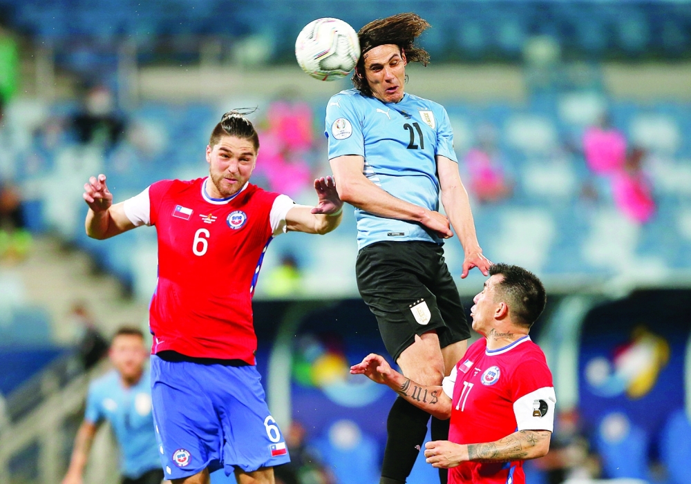 Uruguay's Edinson Cavani in action with Chile's Francisco Sierralta. -- Reuters