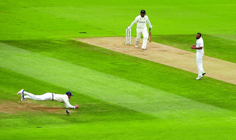 India's Shubman Gill takes a catch to dismiss New Zealand's Ross Taylor off the bowling of India's Mohammad Shami. -- Reuters