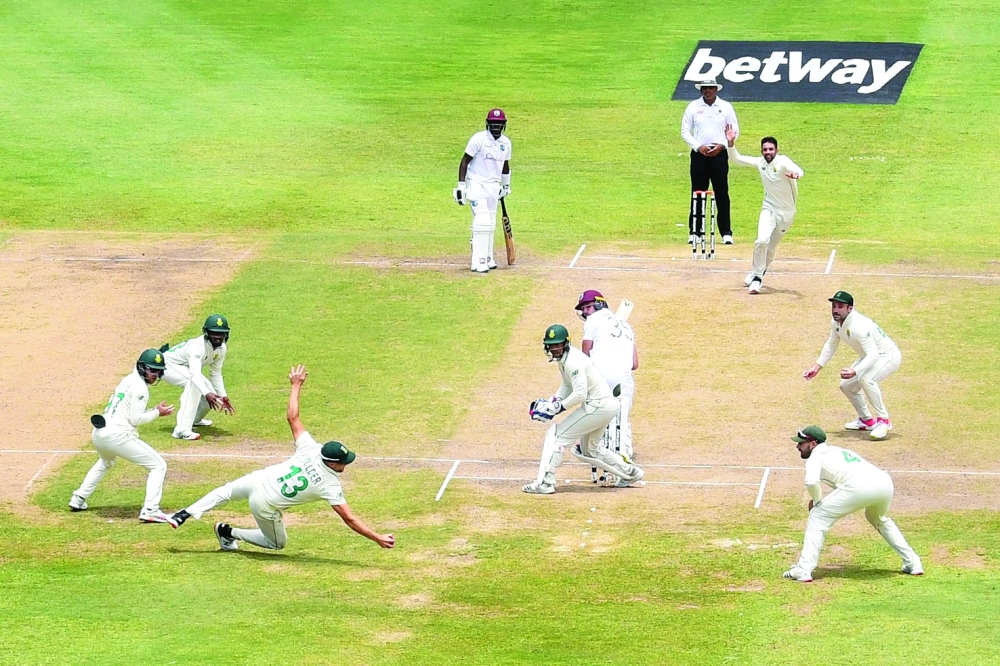 Wiaan Mulder (3rd L) takes the catch off Keshav Maharaj (Top R) of South Africa to dismiss Joshua de Silva (C) of West Indies during day 4 of the second Test at Gros Islet. -- AFP