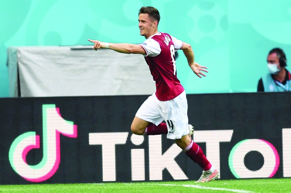 Austria's midfielder Christoph Baumgartner celebrates after scoring the opening goal. -- AFP 
