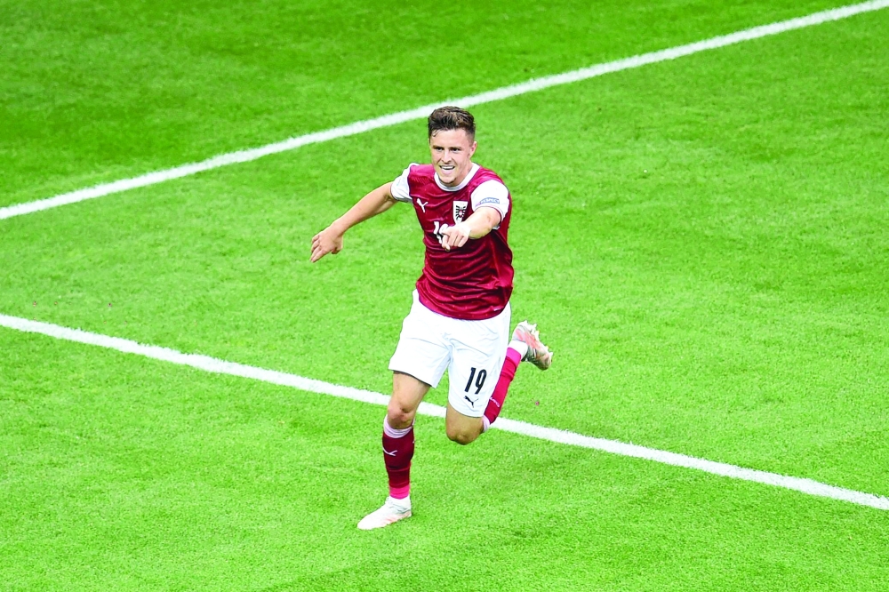Austria's midfielder Christoph Baumgartner celebrates after scoring the opening goal. -- AFP