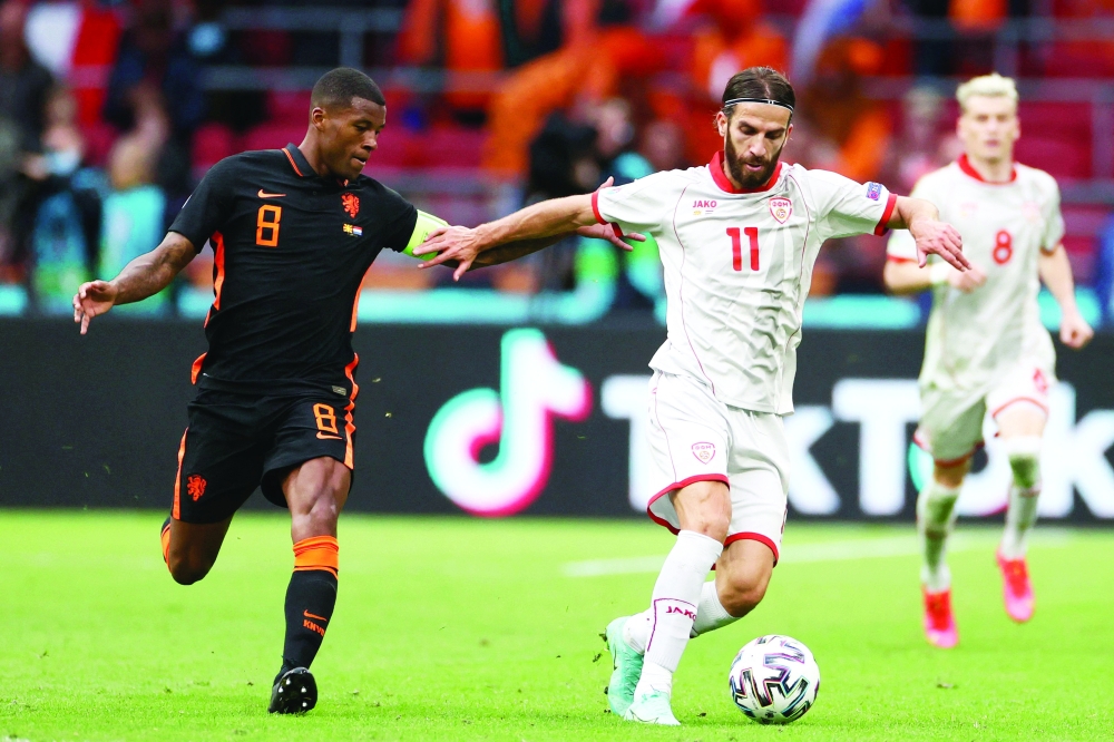 Netherlands' midfielder Georginio Wijnaldum (L) vies with North Macedonia's midfielder Ferhan Hasani. -- AFP