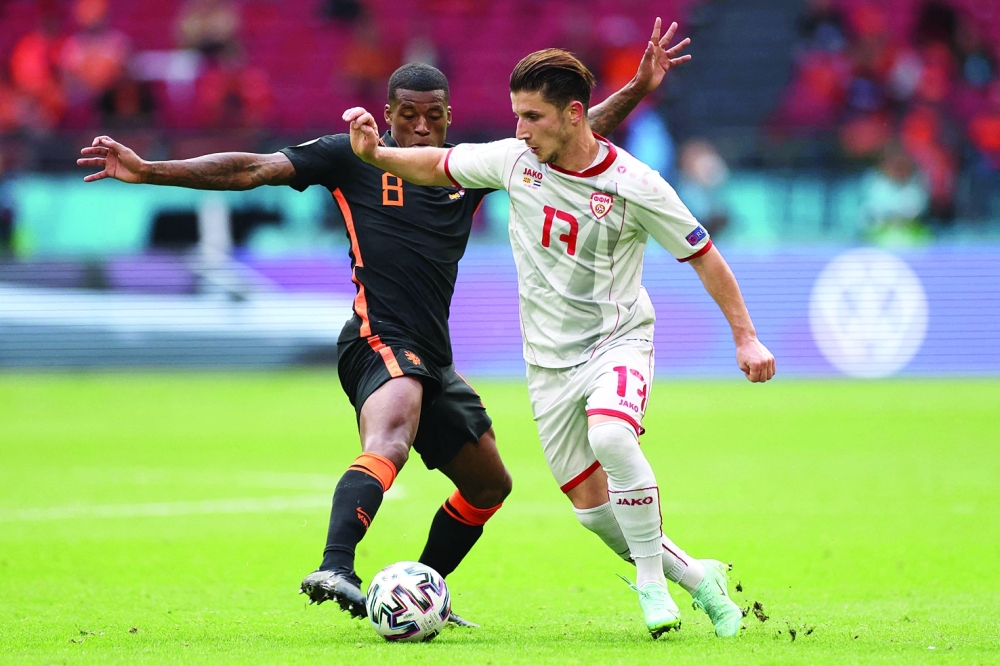 Netherlands' midfielder Georginio Wijnaldum (L) vies with North Macedonia's midfielder Enis Bardhi. -- AFP