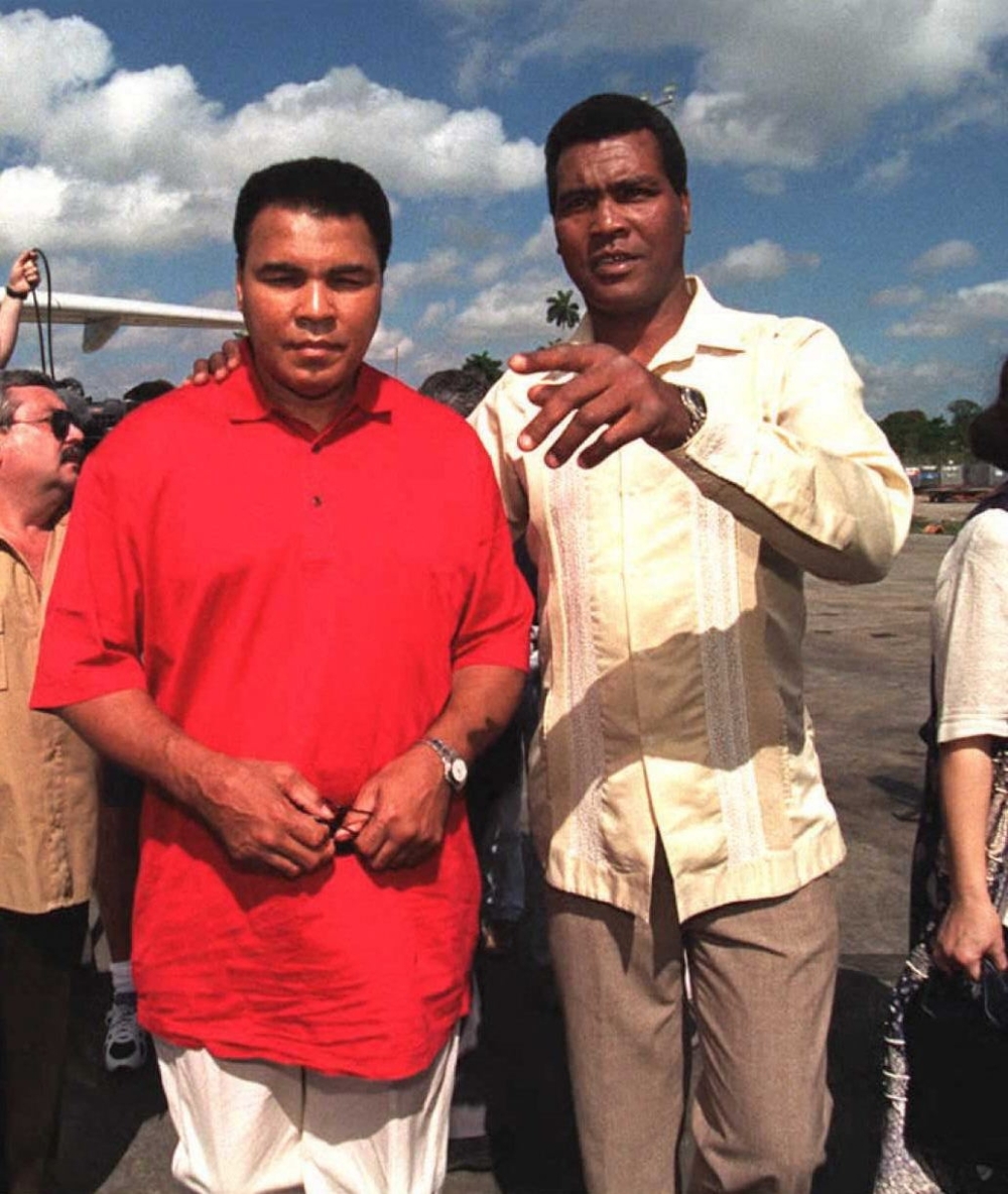 Former world heavyweight champion Muhammad Ali(L) of the US, is escorted by former Cuban boxer Teofilo Stevenson
