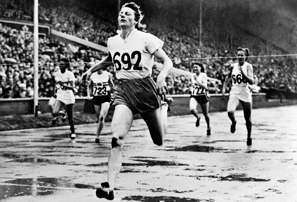 Deutch champion Fanny Blankers-Koen crosses the finish line of the 200m events, in Wembley Stadium, London, 