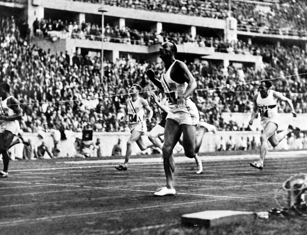 Jesse" (James Cleveland) Owens crosses the finish line to win the 100m events, during Olympic Games in Berlin.  