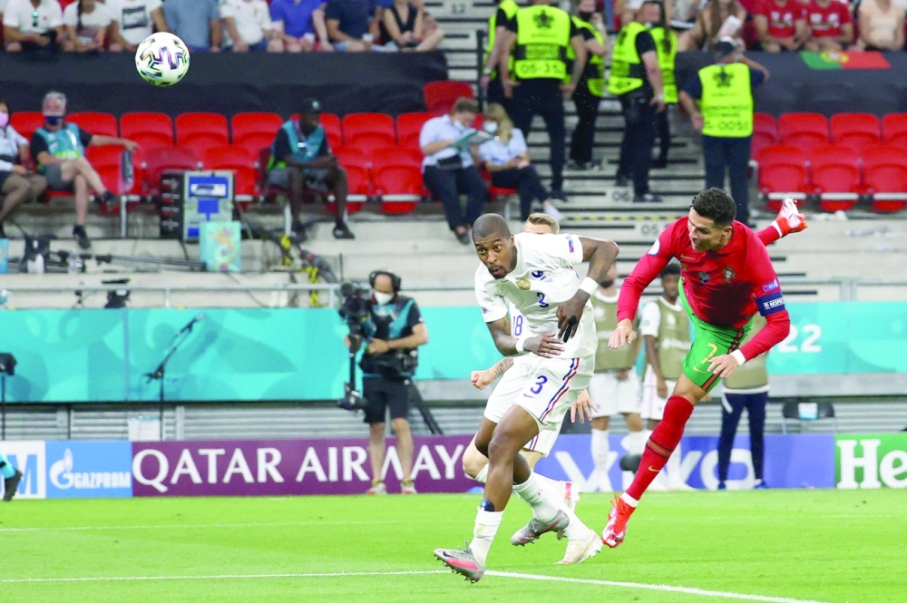 France's Presnel Kimpembe (L) fights for the ball with Portugal's Cristiano Ronaldo in Budapest. -- AFP