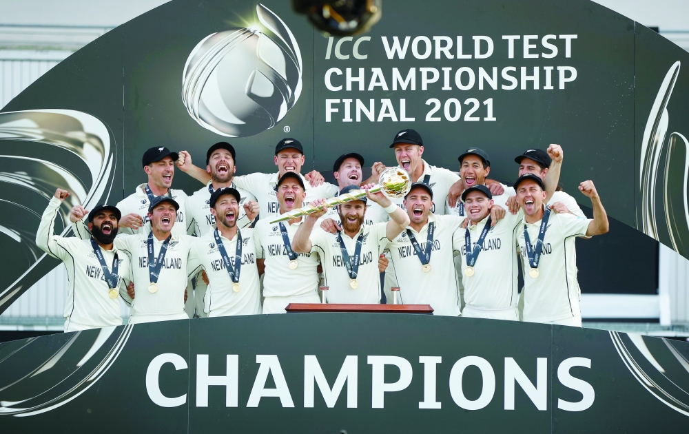New Zealand's Kane Williamson and teammates celebrate with the trophy after winning the final of the ICC World Test Championship. -- Reuters