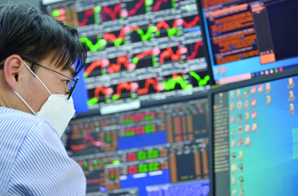 A currency dealer monitors exchange rates in a trading room at KEB Hana Bank in Seoul. - AFP