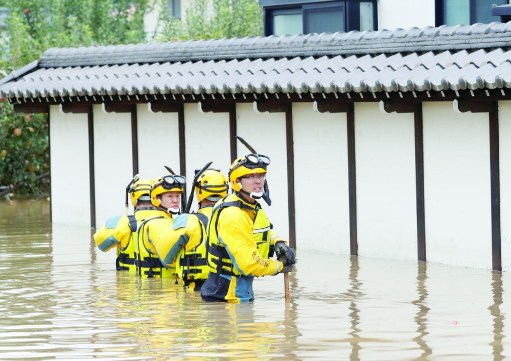 Police search a flooded area in the aftermath of Typhoon Hagibis, which caused severe floods at the Chikuma River in Nagano Prefecture. - Reuters File Photo