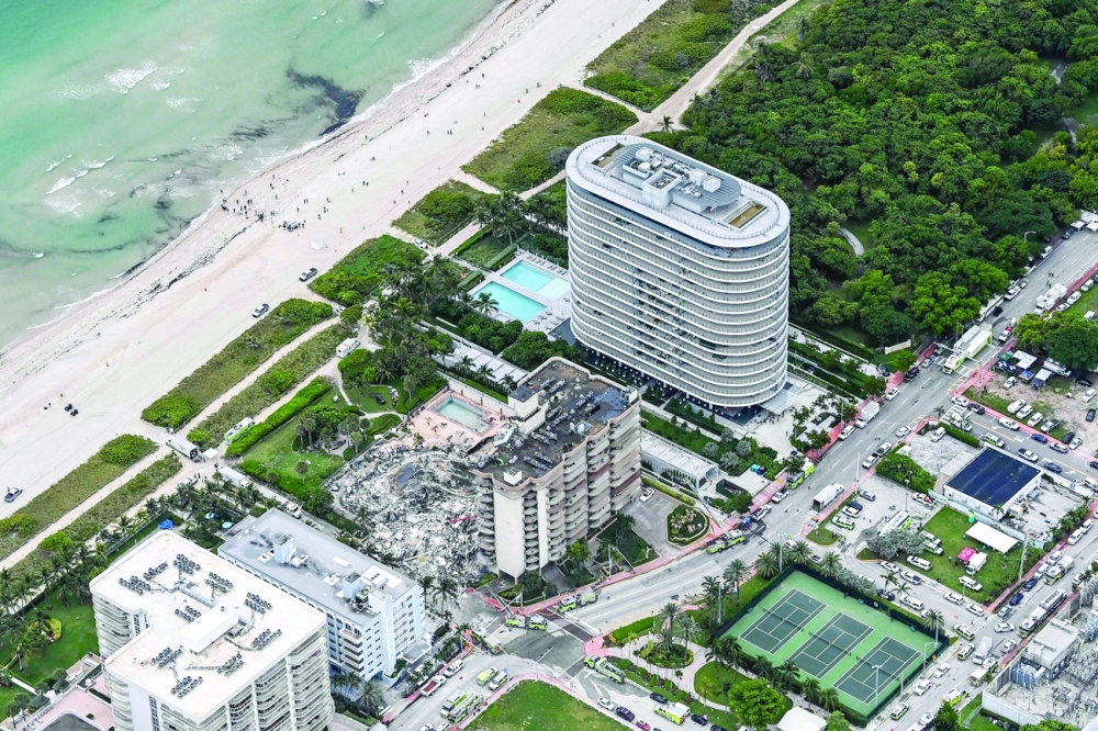 Aerial view shows search and rescue personnel working on site after the partial collapse of the Champlain Towers South in Surfside, north of Miami Beach. - AFP