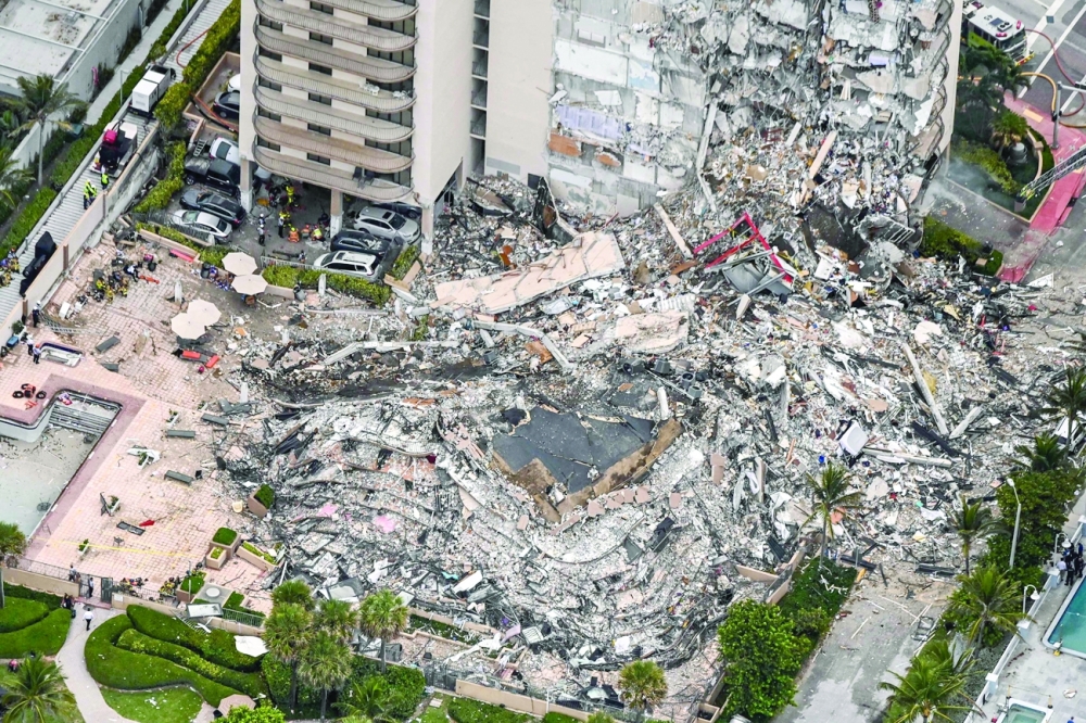 Aerial view shows search and rescue personnel working on site after the partial collapse of the Champlain Towers South in Surfside, north of Miami Beach. - AFP