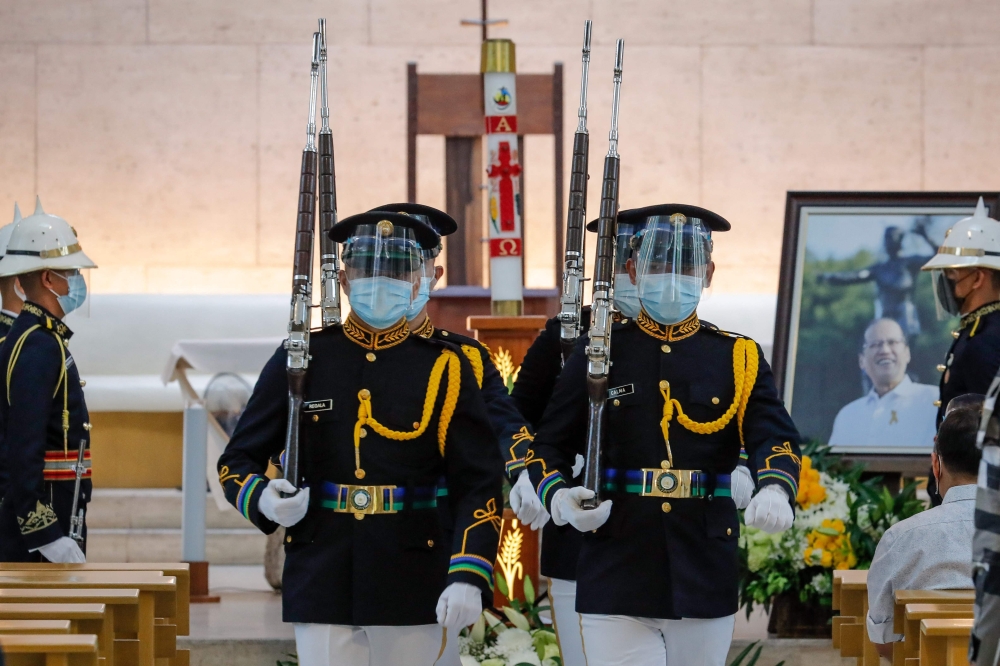 Military honour guards change shifts during a public viewing for former Philippine president Benigno Aquino at the Church of Gesu, Ateneo de Manila University in Manila on June 25