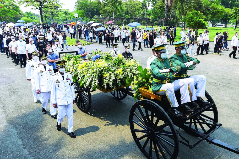 Honour guards transport the urn of former Philippine President Benigno Aquino III, at the Manila Memorial Park, Metro Manila, Philippines. - Reuters
