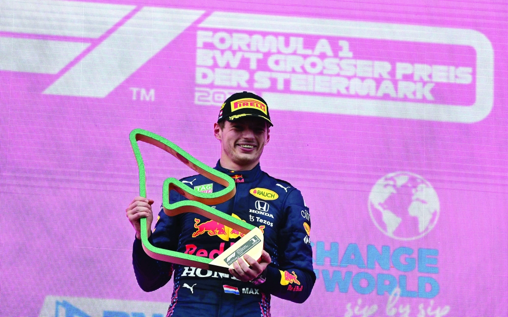 Red Bull's Dutch driver Max Verstappen poses on the podium with his trophy after winning the Formula One Styrian Grand Prix at the Red Bull Ring race track in Spielberg, Austria, on June 27, 2021. / AFP / ANDREJ ISAKOVIC

