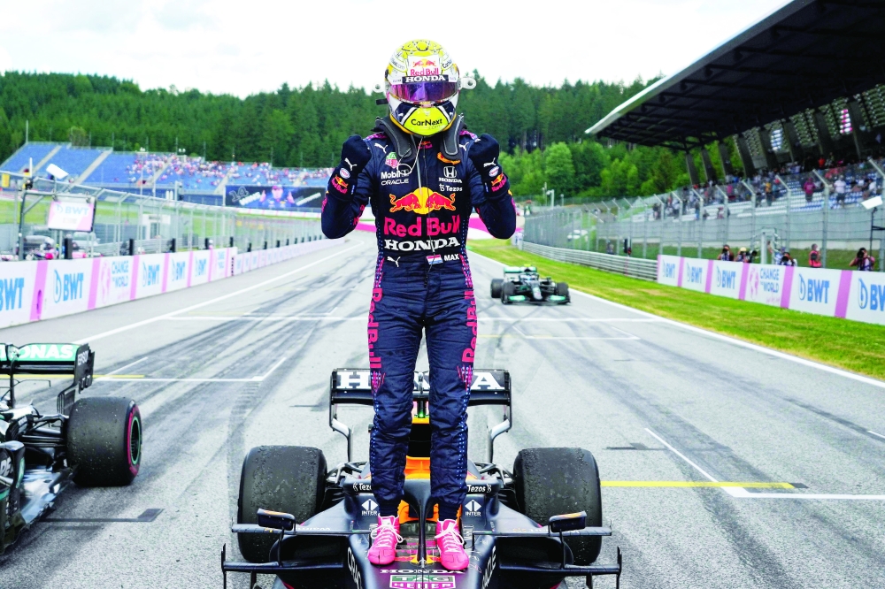 Winner Red Bull's Dutch driver Max Verstappen celebrates after the Formula One Styrian Grand Prix at the Red Bull Ring race track in Spielberg, Austria, on June 27, 2021. / AFP / POOL / Darko Vojinovic

