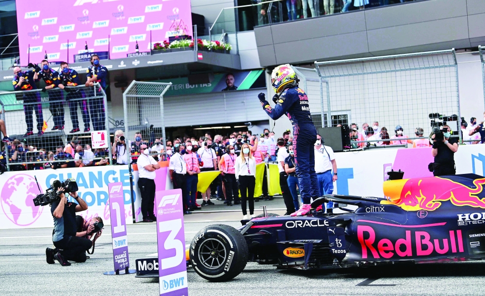 Red Bull's Dutch driver Max Verstappen stands on his car after winning the Formula One Styrian Grand Prix at the Red Bull Ring race track in Spielberg, Austria, on June 27, 2021. / AFP / ANDREJ ISAKOVIC

