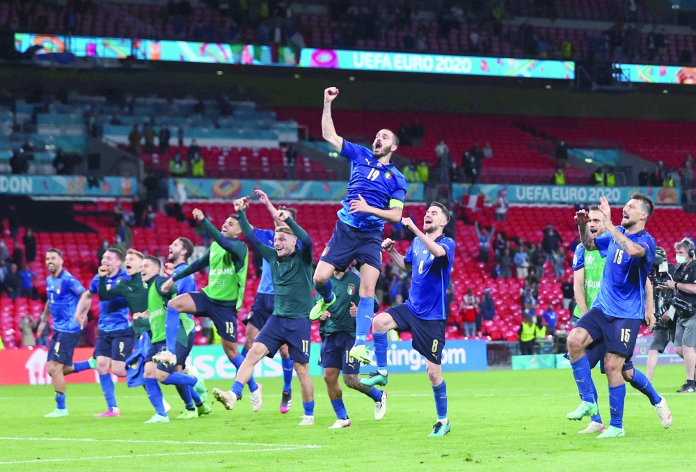 Italy's Leonardo Bonucci celebrates with teammates after the match. -- Reuters