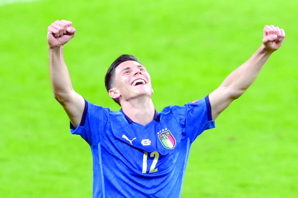 Italy's midfielder Matteo Pessina celebrates at the end of extra-time. -- AFP