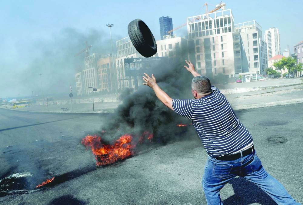 Demonstrators burn tires to block the Martyrs' Square in the centre of Beirut as they protest against dire living conditions amidst the ongoing economical and political crisis. - AFP 