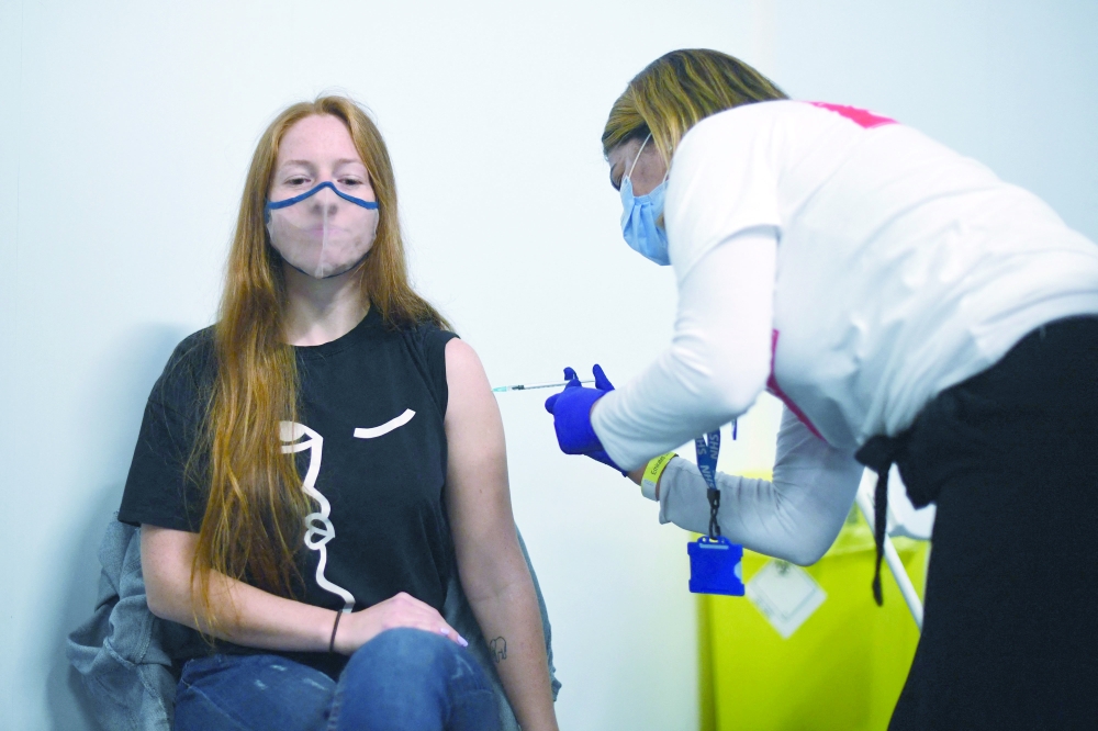 A woman receives Covid-19 vaccine in London. — AFP