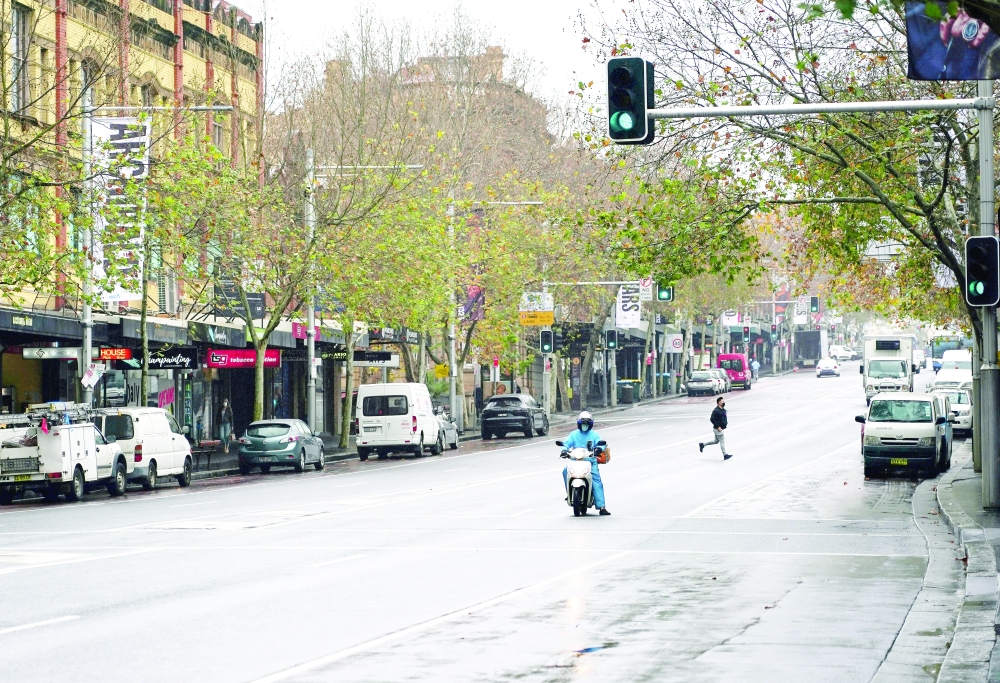 A delivery courier wears a face mask on the usually busy Oxford Street in the city centre during a lockdown to curb the spread of coronavirus outbreak in Sydney. — Reuters