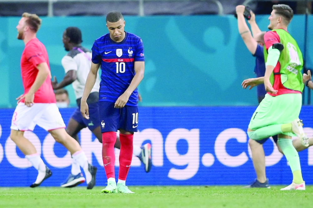 France's forward Kylian Mbappe reacts after missing the final penalty. -- AFP