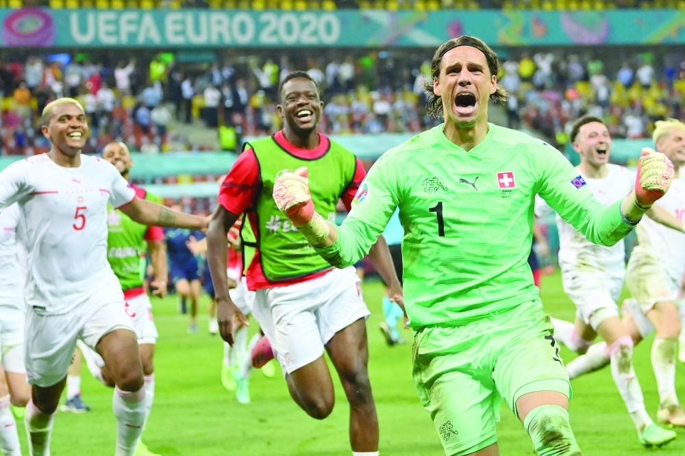 Switzerland's goalkeeper Yann Sommer reacts after saving a shot by France's forward Kylian Mbappe in the penalty shootout. -- AFP