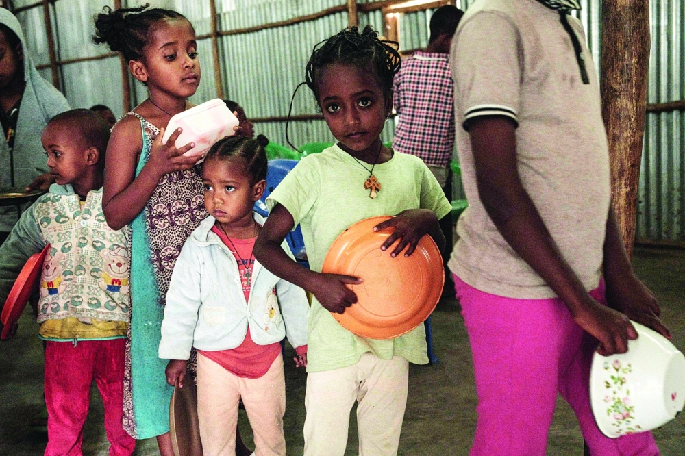 Children, who fled the violence in Ethiopia’s, Tigray region, wait in line for breakfast organised by a self-volunteer Mahlet Tadesse, 27, in Mekelle, the capital of Tigray region. — AFP