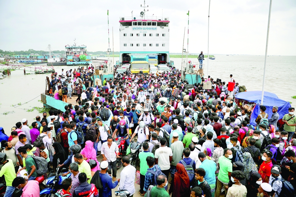 People board an overcrowded ferry as they go home a day before imposing a countrywide lockdown in Munshiganj, outskirts of Dhaka, on Wednesday. - Reuters