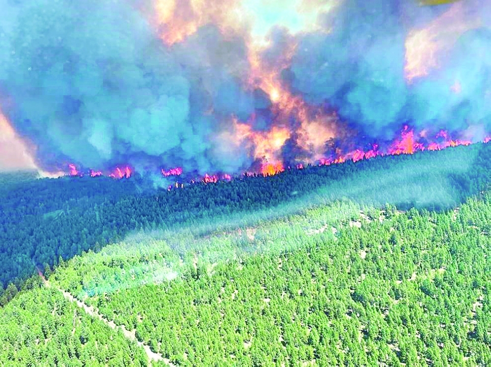 Smoke and flames are seen during the Sparks Lake wildfire at Thompson-Nicola Regional District, British Columbia, Canada. -- Reuters