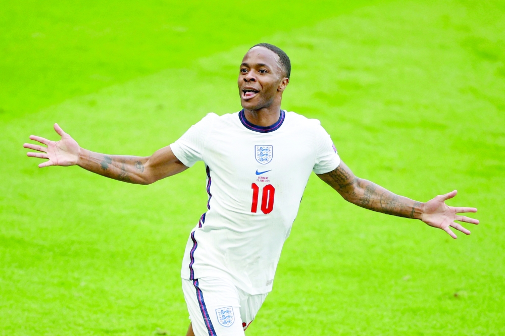 England's Sterling celebrates the first goal. -- AFP