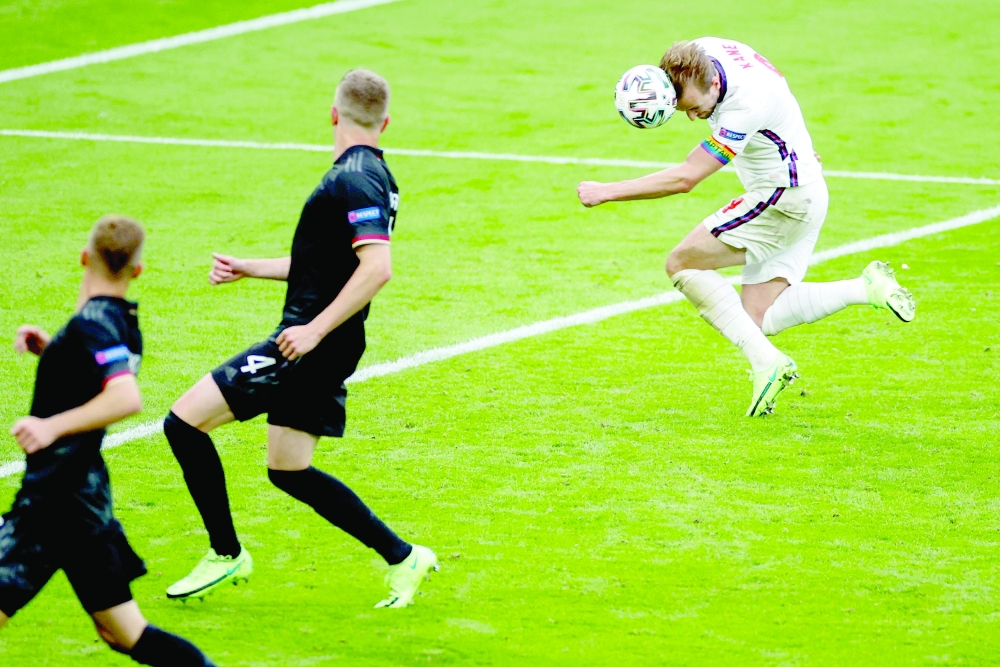 England's Harry Kane (R) scores the second goal against Germany at Wembley Stadium in London. -- AFP