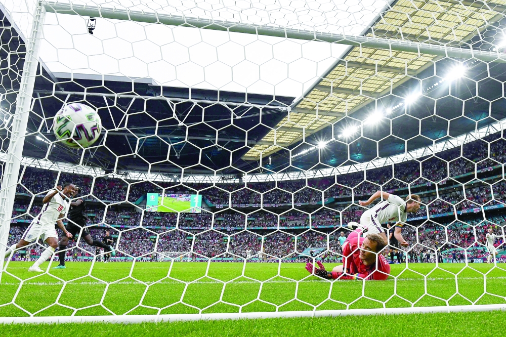 Raheem Sterling (L) celebrates after Harry Kane (R) scored England's second goal. -- AFP