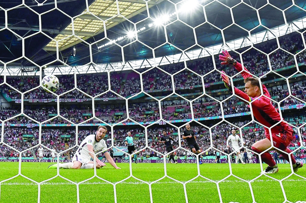 Harry Kane (L) scores England's second goal. -- AFP 