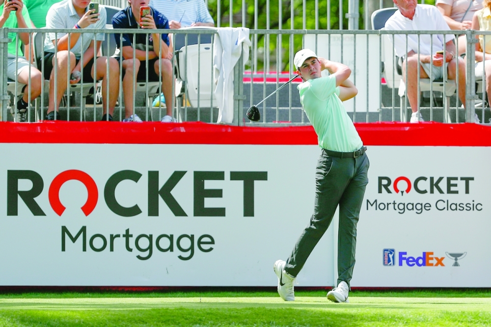 Davis Thompson hits a shot from the 1st tee during the first round of the Rocket Mortgage Classic. -- USA Today Sports