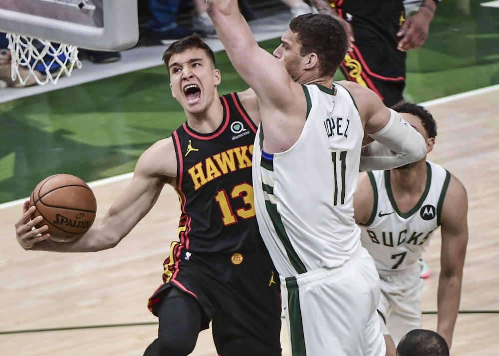 Atlanta Hawks guard Bogdan Bogdanovic (13) takes a shot against Milwaukee Bucks center Brook Lopez (11) in the fourth quarter. -- USA Today Sports
