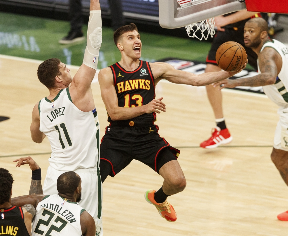 Atlanta Hawks guard Bogdan Bogdanovic (13) shoots against Milwaukee Bucks center Brook Lopez (11) during the fourth quarter during game five of the Eastern Conference Finals. -- USA Today Sports
