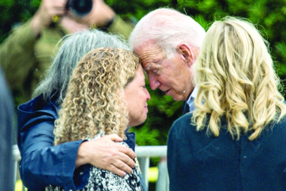 US President Joe Biden and US First Lady Jill Biden (2R) meet Miami Dade County Mayor Daniella Levine Cava as he visits the 'Surfside Wall of Hope & Memorial', near the partially collapsed Champlain Towers South condo building in Surfside, Florida. - AFP