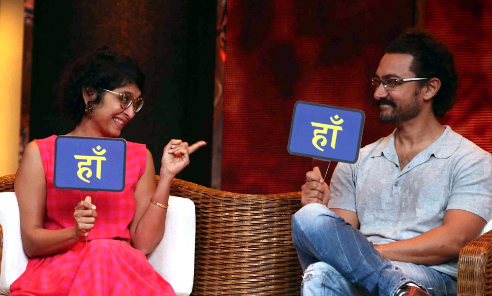 Aamir Khan (R) and his wife director Kiran Rao Khan interact during the television chat show 