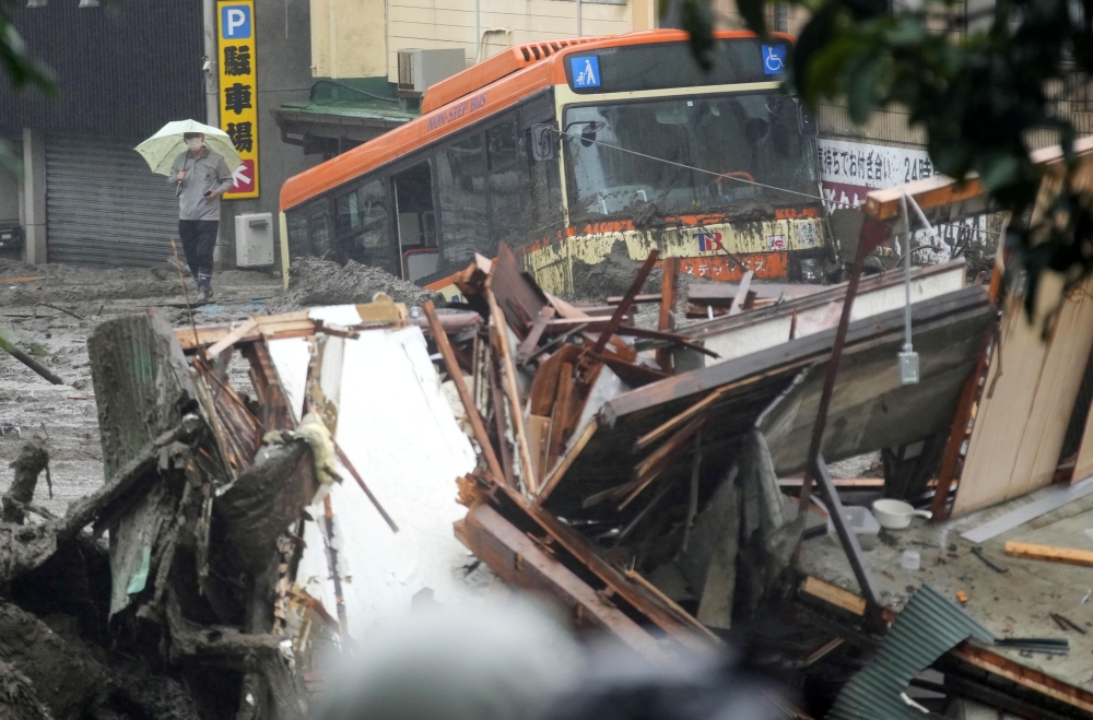A damaged bus and debris of the houses are seen at a mudslide site following heavy rain at Izusan district in Atami, Japan July 3, 2021.