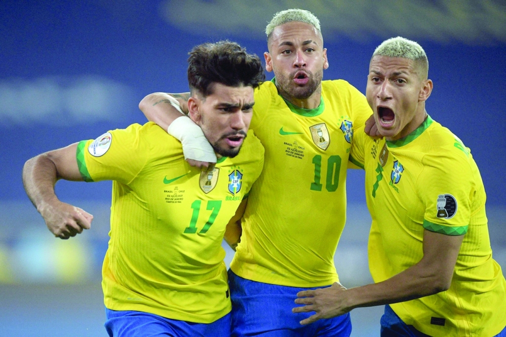 Brazil's Lucas Paqueta (L) celebrates with Neymar (C) and Richarlison after scoring against Chile. -- AFP