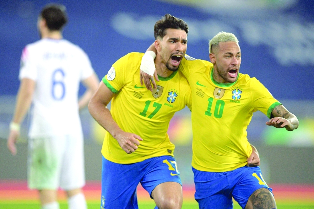 Brazil's Lucas Paqueta (L) celebrates with Neymar after scoring against Chile. -- AFP
