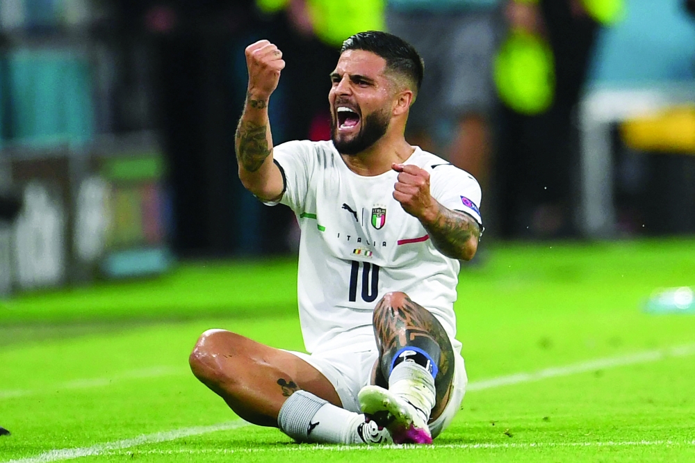 Italy's forward Lorenzo Insigne celebrates scoring their second goal. -- AFP