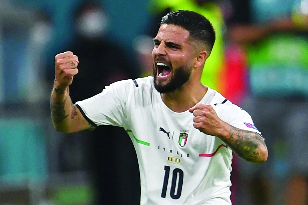 Italy's forward Lorenzo Insigne celebrates scoring their second goal. -- AFP