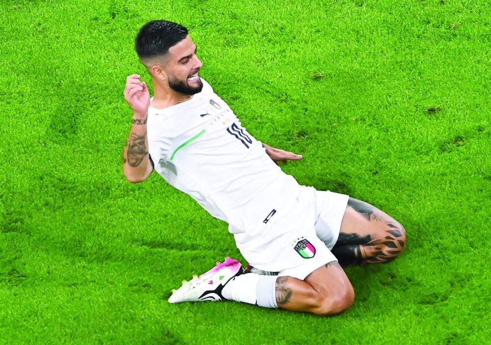 Italy's Lorenzo Insigne celebrates scoring their second goal. -- Reuters