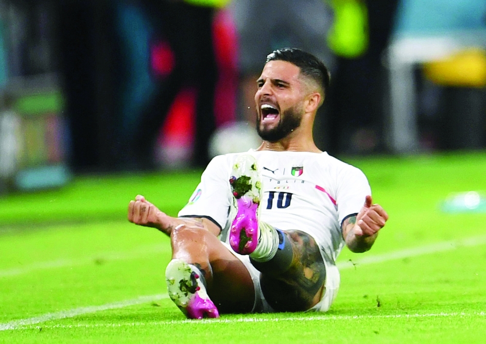 Italy's Lorenzo Insigne celebrates scoring their second goal. -- Reuters