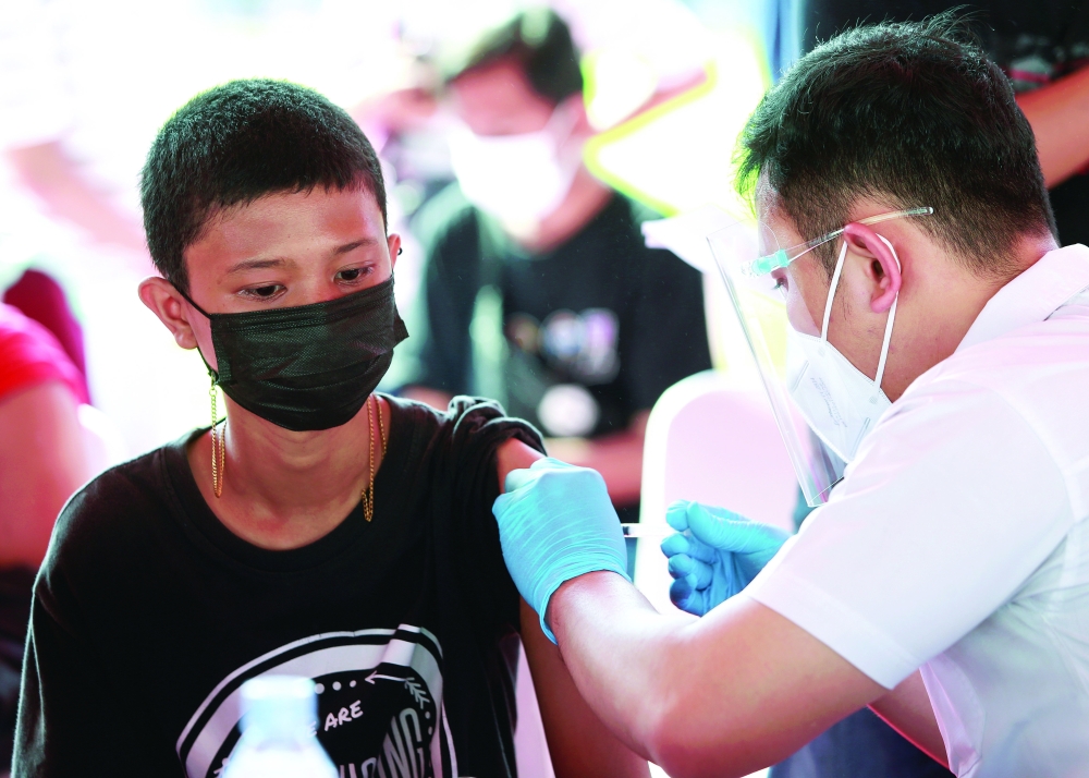 A boy receives a dose of the vaccine against the coronavirus disease during the mass vaccination programme in Jakarta. - Reuters 
