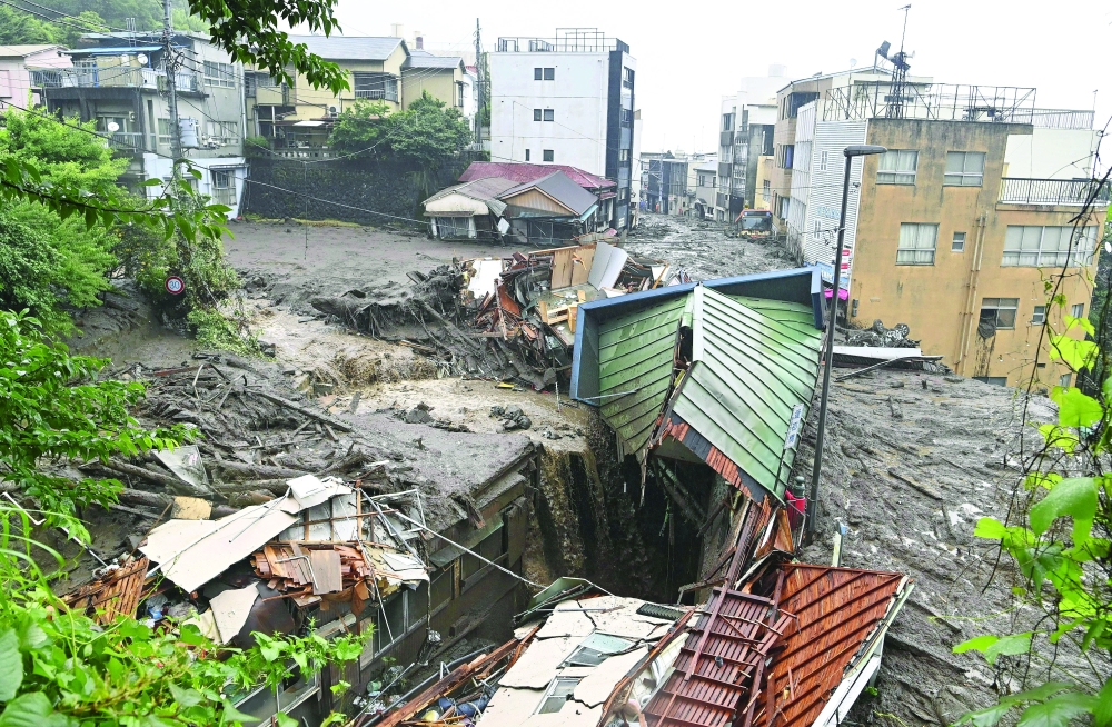 Houses damaged by a mudslide following heavy rain are seen at Izusan district in Atami. - Reuters 
