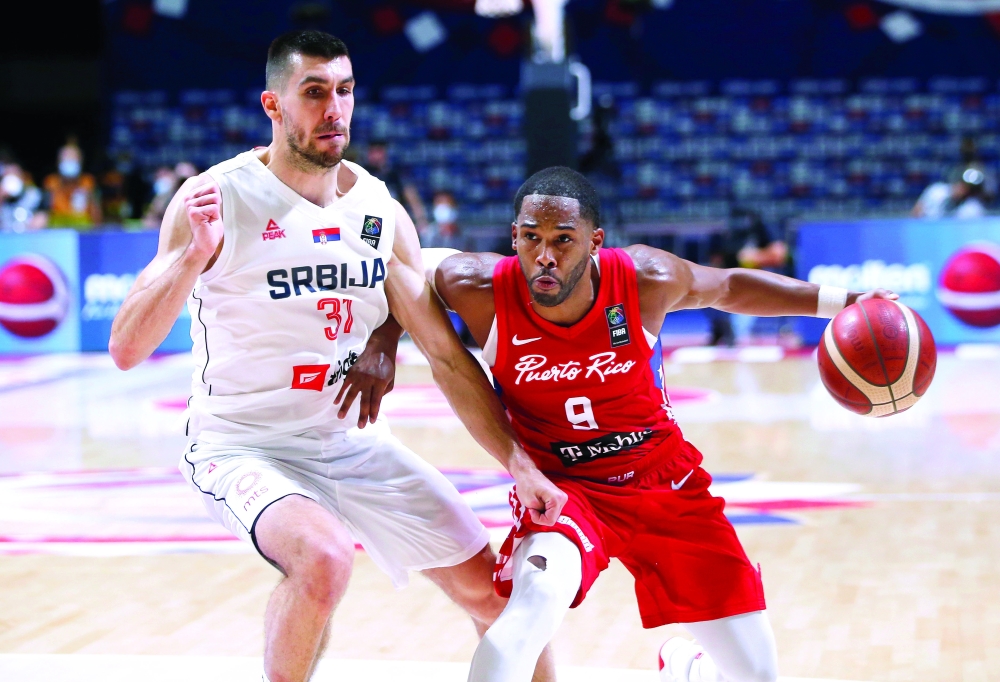 Puerto Rico's Gary Browne in action with Serbia's Ognjen Dobric. -- Reuters